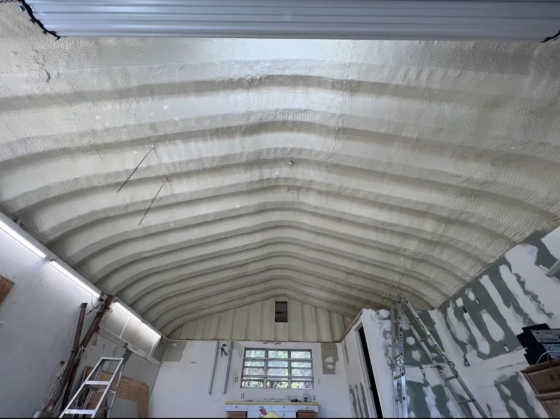 Spray polyurethane foam applied to the underside of a metal roof deck in Saratoga Springs